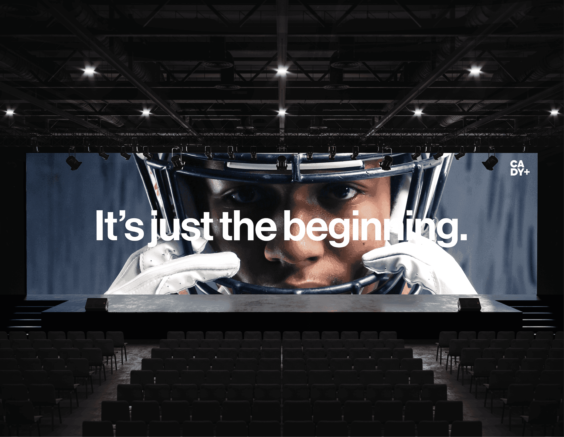 Stage Screen Graphic. A large event screen featuring a dramatic athlete close-up and the line “It’s just the beginning.”